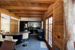Step into a cozy kitchen with a rustic wooden ceiling and walls, creating a warm and inviting atmosphere.