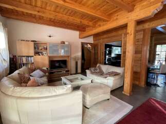 Experience rustic charm in this stunning home featuring exposed wooden beams and cozy living spaces.