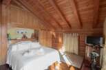 Experience the warmth of this cozy bedroom, featuring stunning wooden accents throughout.