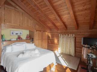 Experience the warmth of this cozy bedroom, featuring stunning wooden accents throughout.