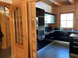 Step into this stunning kitchen with sleek black cabinetry and modern appliances.