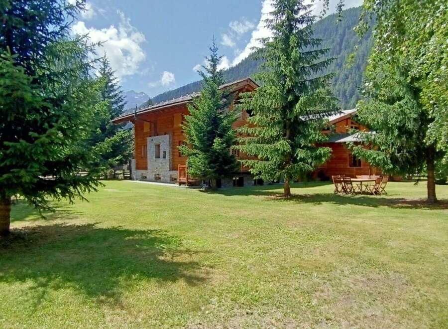 Escape to a stunning wooden chalet nestled amidst lush greenery.