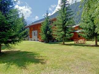 Escape to a stunning wooden chalet nestled amidst lush greenery.