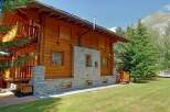 Discover the charm of this stunning wooden chalet nestled in a picturesque mountain setting.