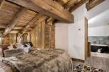 Experience rustic luxury in this stunning bedroom.