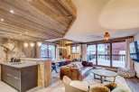 Experience luxury living in this stunning chalet, featuring a warm and inviting interior with wooden accents throughout.