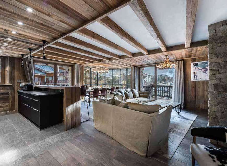Experience luxury living in this stunning chalet, featuring a rustic wooden interior and breathtaking mountain views.
