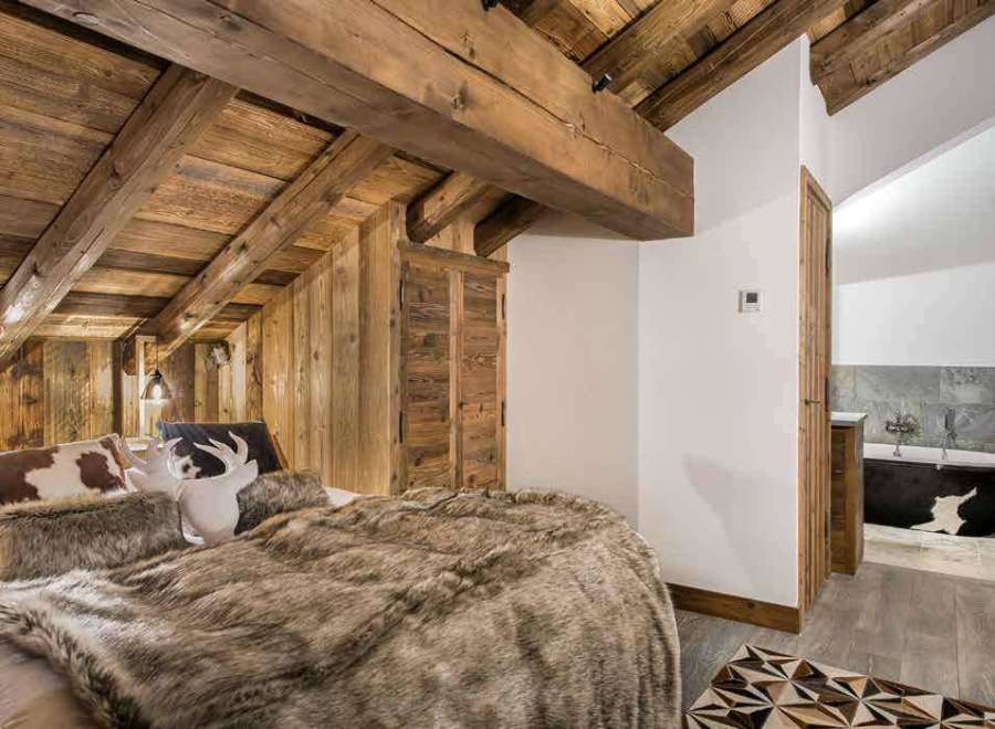 Experience rustic luxury in this stunning bedroom.
