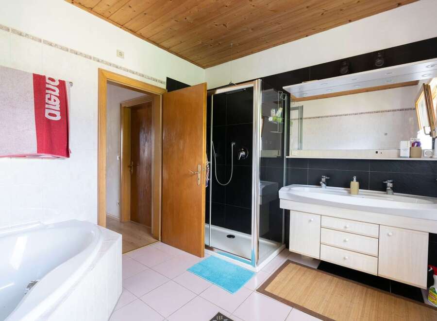 Step into this inviting bathroom, featuring a sleek shower and a spacious vanity.