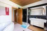 Step into this inviting bathroom, featuring a sleek shower and a spacious vanity.