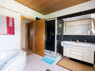 Step into this inviting bathroom, featuring a sleek shower and a spacious vanity.
