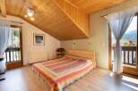 Discover a cozy bedroom with a unique wooden ceiling design.