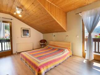 Discover a cozy bedroom with a unique wooden ceiling design.