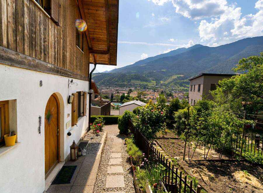 Discover the charm of this beautiful property, featuring a stunning wooden facade and a welcoming entrance.