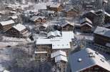 Experience the charm of a snow-covered village with stunning chalets.