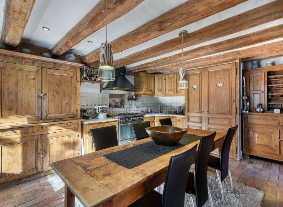 Step into a rustic kitchen with charming wooden cabinets and exposed beams, creating a warm and inviting atmosphere.