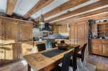 Step into a rustic kitchen with charming wooden cabinets and exposed beams, creating a warm and inviting atmosphere.