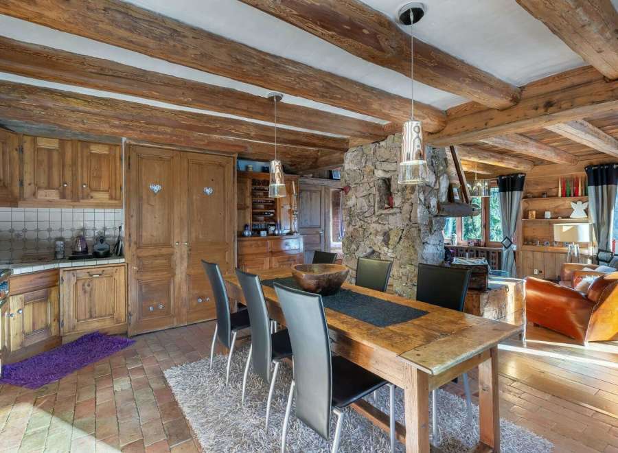 Experience rustic charm in this stunning property, featuring exposed wooden beams and a cozy stone fireplace.
