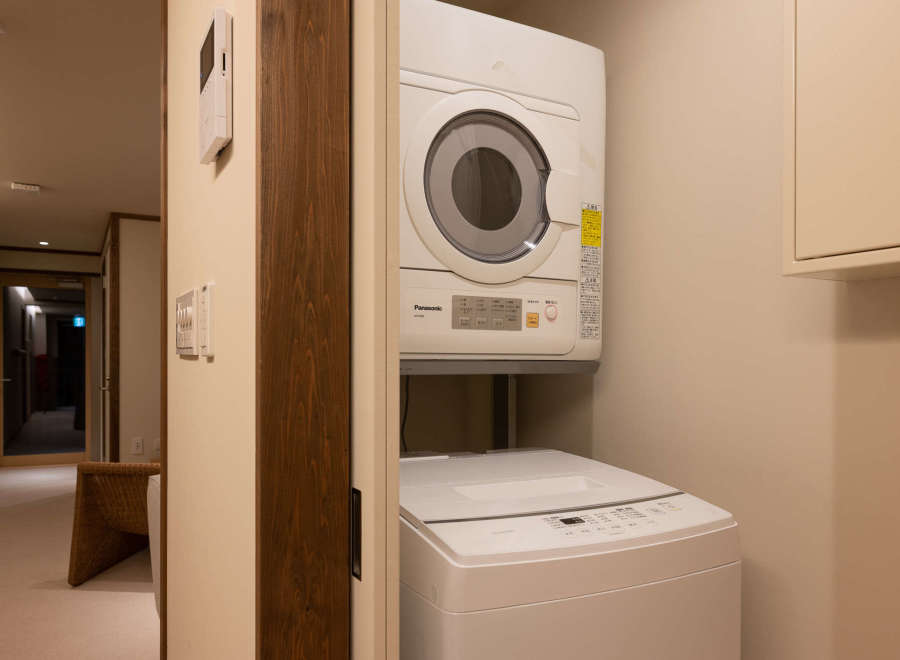 This modern laundry room features a stackable washer and dryer set, perfect for guests who need to do laundry during their stay.