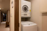 This modern laundry room features a stackable washer and dryer set, perfect for guests who need to do laundry during their stay.
