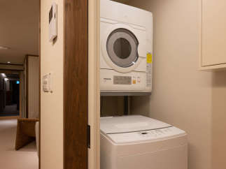 This modern laundry room features a stackable washer and dryer set, perfect for guests who need to do laundry during their stay.