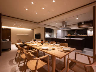 This stunning property boasts a spacious open-plan living area seamlessly integrating a modern kitchen and a large dining table perfect for gatherings.