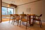 This stunning dining area boasts a spacious wooden table surrounded by six comfortable chairs, perfect for enjoying meals with loved ones.