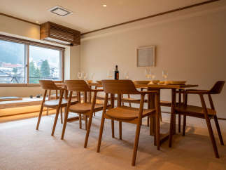 This stunning dining area boasts a spacious wooden table surrounded by six comfortable chairs, perfect for enjoying meals with loved ones.