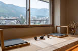 This serene room boasts a stunning mountain view through large windows, complemented by a minimalist tatami mat seating area perfect for relaxation.