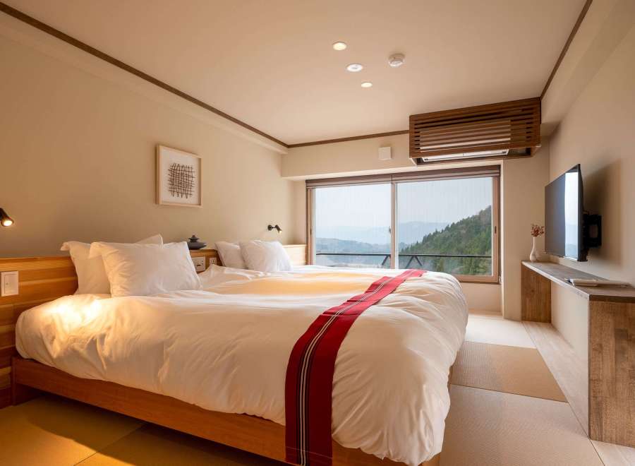 Wake up to breathtaking mountain views from this serene hotel room.