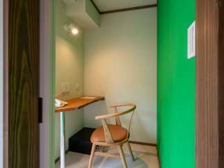 Cozy workspace nook with a wooden desk and chair, perfect for a quiet moment.
