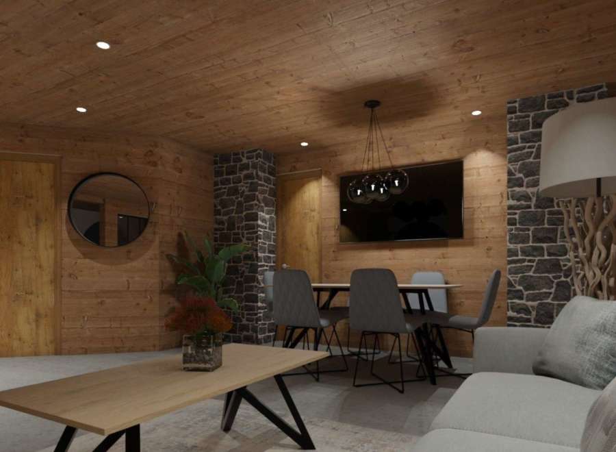 Cozy chalet living room with wood walls and stone accents.