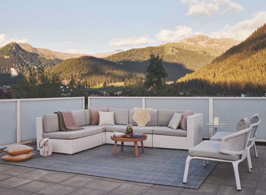 Luxury mountain view patio with sectional sofa and chairs.