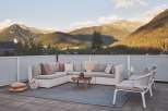 Luxury mountain view patio with sectional sofa and chairs.