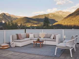 Luxury mountain view patio with sectional sofa and chairs.
