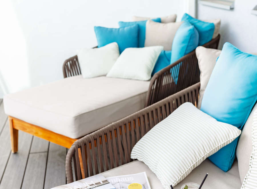Relax and unwind on this luxurious balcony, complete with comfortable lounge seating and refreshing drinks.