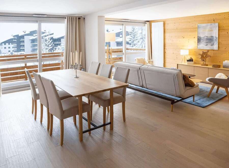This stunning apartment boasts a spacious open-plan living area with floor-to-ceiling windows offering breathtaking mountain views.