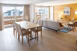 This stunning apartment boasts a spacious open-plan living area with floor-to-ceiling windows offering breathtaking mountain views.