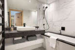 Step into luxury with this stunning bathroom featuring a sleek, modern design.