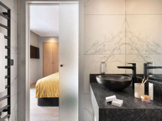 Step into luxury with this stunning bathroom, seamlessly connected to a stylish bedroom.