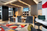 Step into the inviting lobby of this modern property, featuring a stylish reception area with sleek countertops and a striking geometric rug.