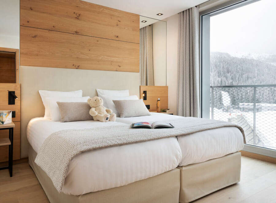 Experience luxury and comfort in this stunning bedroom, featuring a cozy bed and a serene ambiance.