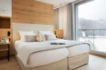 Experience luxury and comfort in this stunning bedroom, featuring a cozy bed and a serene ambiance.