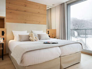 Experience luxury and comfort in this stunning bedroom, featuring a cozy bed and a serene ambiance.