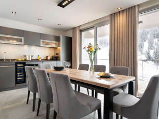 This modern kitchen and dining area offers a stylish space for both cooking and entertaining.