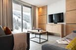 Experience luxury living in this stunning property featuring a modern living room with a breathtaking mountain view.