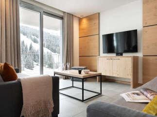 Experience luxury living in this stunning property featuring a modern living room with a breathtaking mountain view.