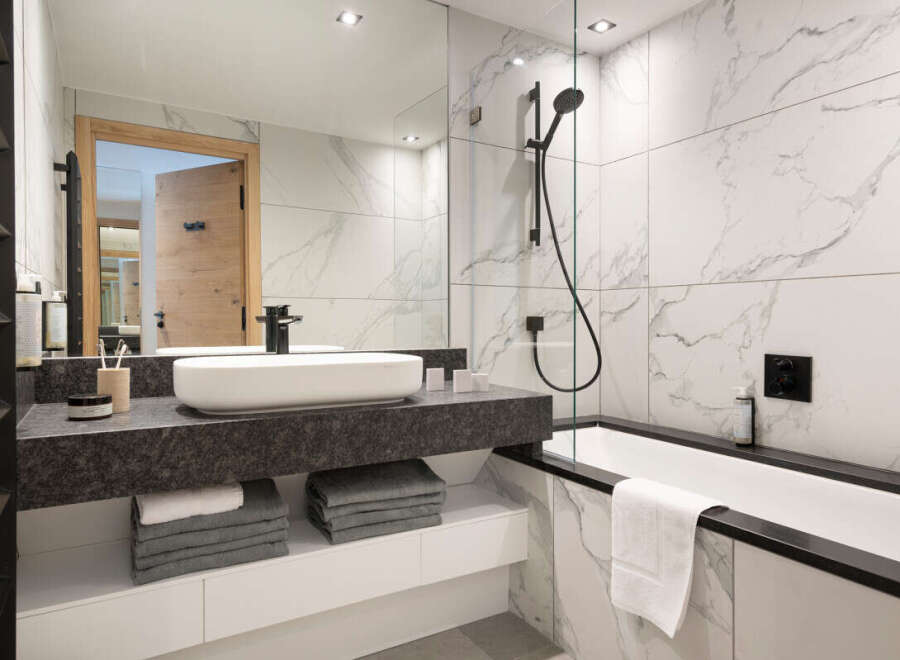 Step into luxury with this stunning bathroom featuring a sleek, modern design.