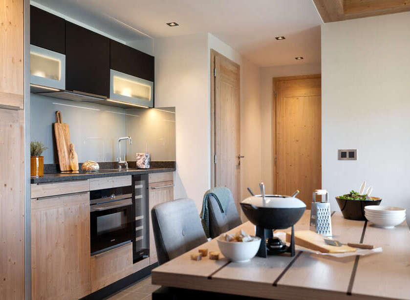 This stunning apartment boasts a modern, fully equipped kitchen with sleek cabinetry and high-end appliances.
