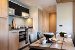 This stunning apartment boasts a modern, fully equipped kitchen with sleek cabinetry and high-end appliances.